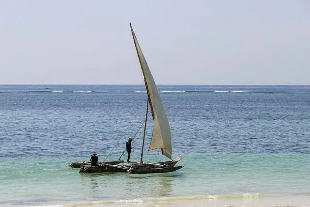 Dhow sailing in Diani Beach, Kenya, with fishermen on the Indian Ocean.