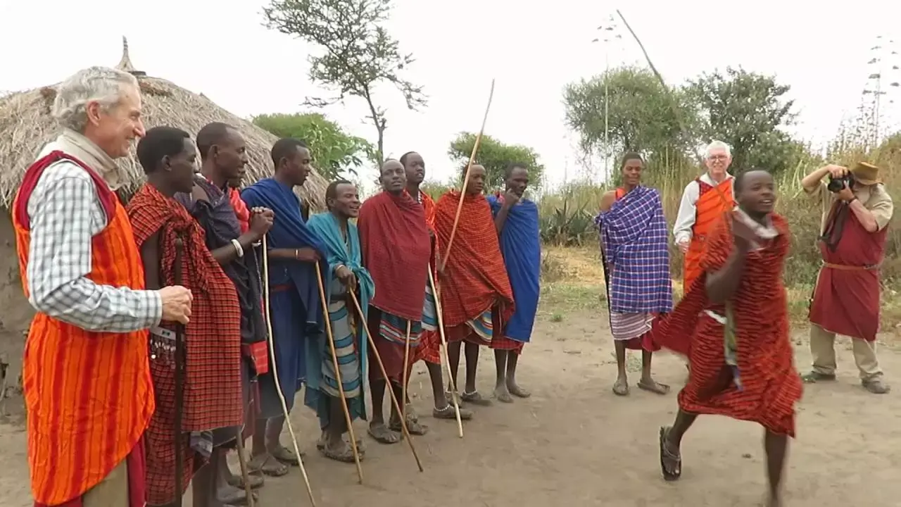 Guests watching a traditional Maasai dance performance during a cultural village visit in Masai Mara